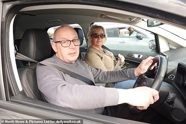David Holmes, 71, and his wife Bev, 61, filling up their vehicle - Bev has decided to begin working from home once a week to save on fuel