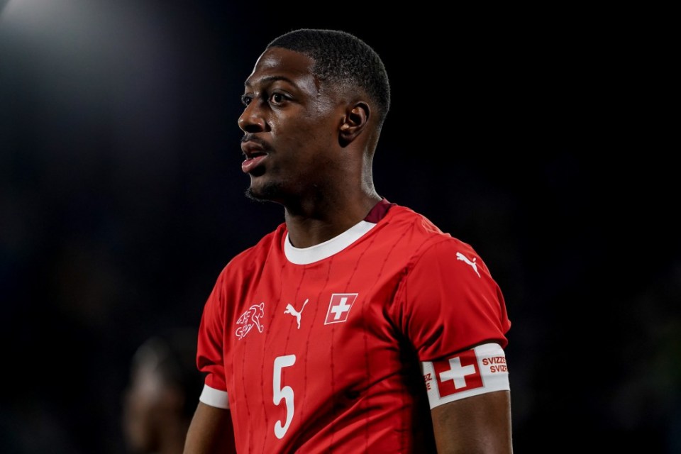 A Swiss Under-21 national team player in a red jersey with the number 5, and the Swiss flag on his sleeve.