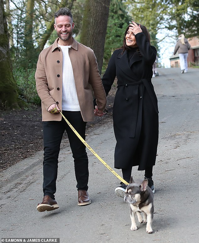 The soap star also wore a pair of black trainers with matching leggings while Tom opted for a white jumper with a brown jacket and black jeans