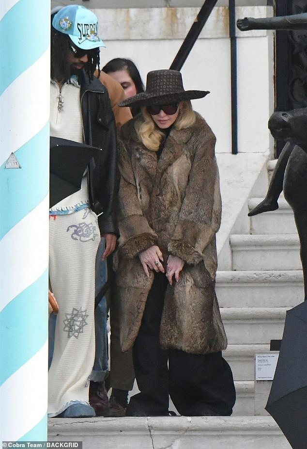 The singer, 67, also sported a black turtle neck top and a matching pair of trousers as she made her way towards a waiting boat