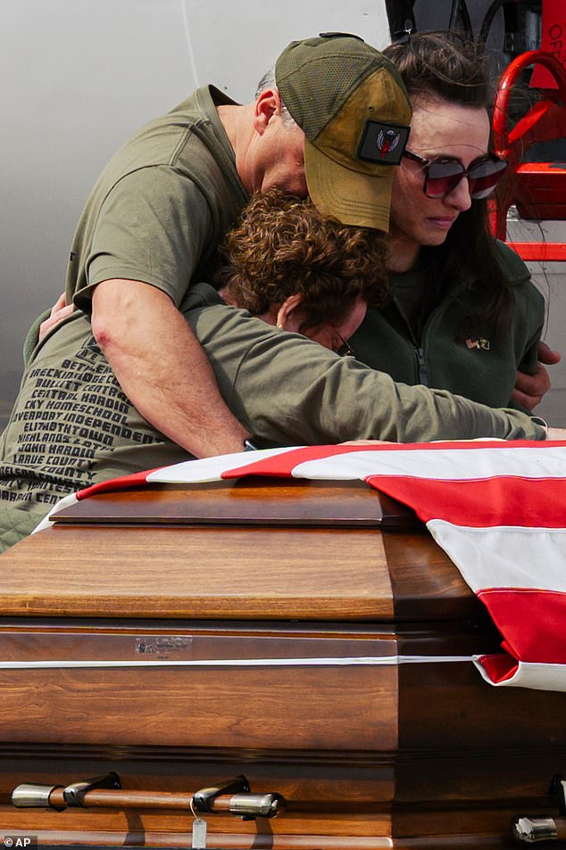Family members stand with the casket carrying the remains of Army Sgt Benjamin N Pennington, 26, of Kentucky, who died after being wounded in a March 1 attack on the same base