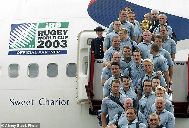 The England rugby squad pose for a photograph with the World Cup at Sydney Airport, as they board the plane - renamed Sweet Chariot - that is bringing them back to London