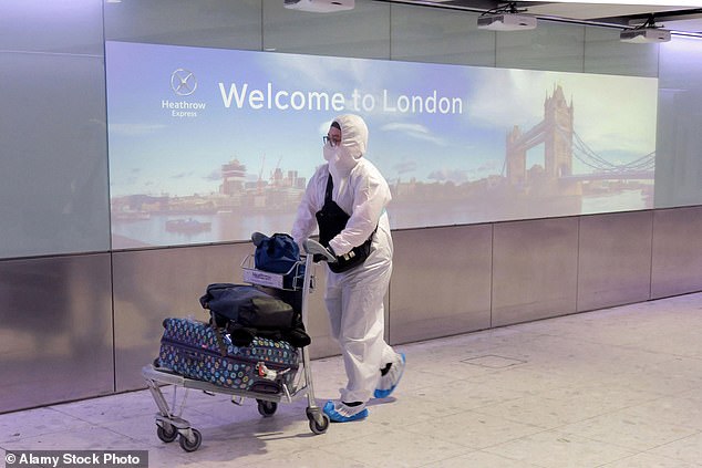 A passenger wearing protective gear is seen at Heathrow Airport on May 1, 2020