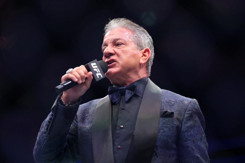 UFC announcer Bruce Buffer holds a microphone and speaks.