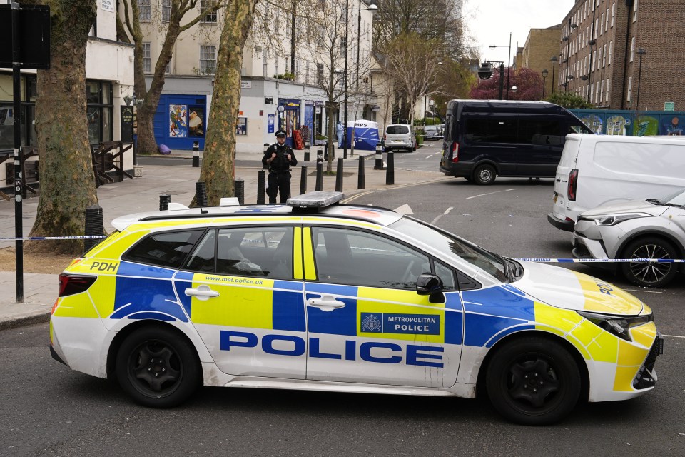 A Metropolitan Police car and officer behind police cordon tape at a crime scene on Chalton Street.