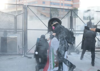 Chaos erupts at 'No Kings' rallies across US with at least 13 arrests, tear gas, and 'tactical alert' declared in LA