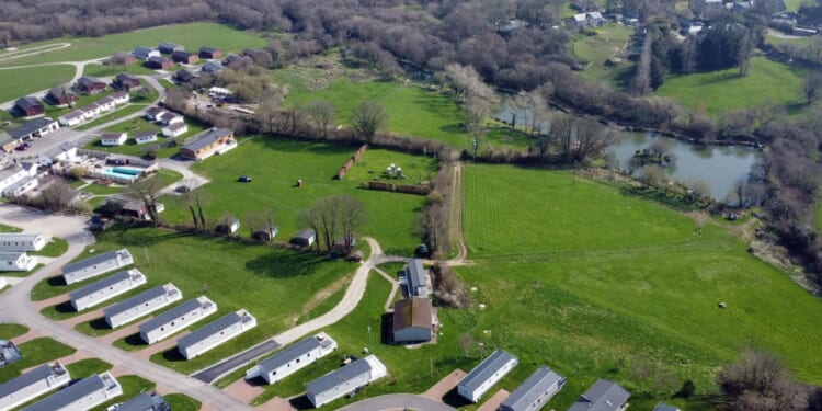 Locals at war with looming 'eyesore' caravan park that 'lights up like Blackpool & means they can't use their HOT TUBS'