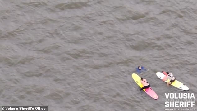 A different angle of the pursuit appears to show the arrest turn into a rescue mission, as the suspect seemed to stop swimming and raised his hands above the water