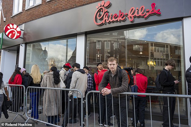 The queue for Chick-fil-A began over the road where a security guard handed customers a ticket allowing them to join a second queue on another street