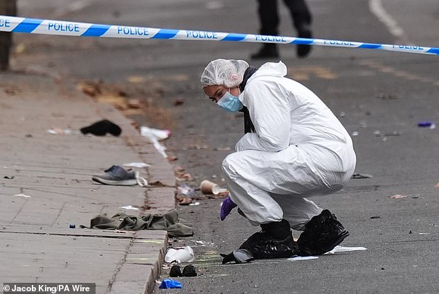 Forensic investigators inspect the scene after the incident in Derby last night