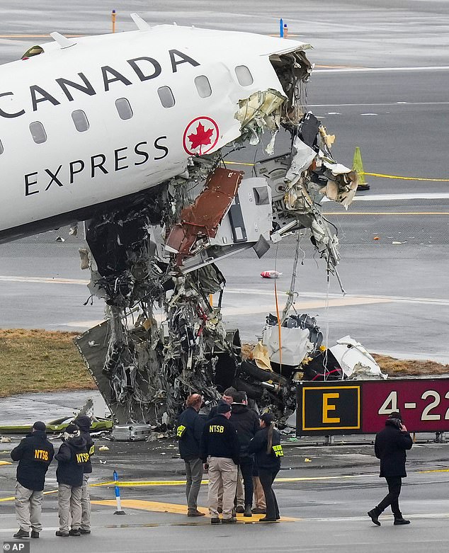 National Transportation Safety Board officials investigate a crash site on the tarmac at LaGuardia Airport in New York City on March 23, 2026