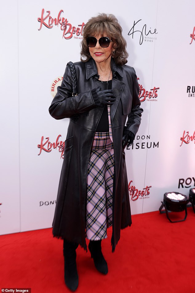 The legendary actress stepped out in a patterned pink skirt and a matching blazer jacket. She layered a long, black trench coat over the co-ord and slipped into a pair of sensible black boots