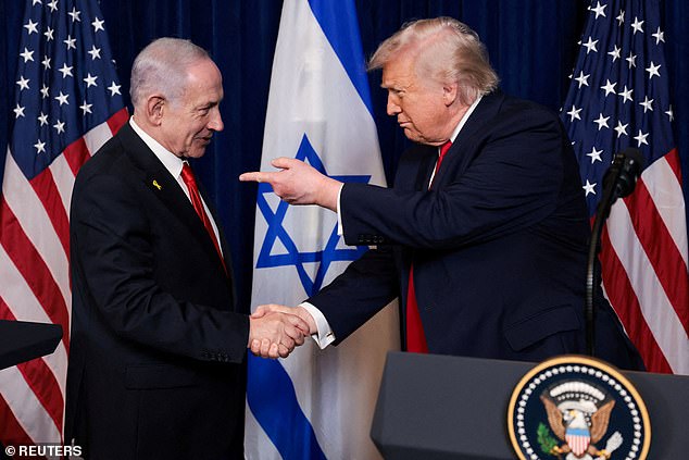 President Donald Trump points his finger towards Israeli Prime Minister Benjamin Netanyahu as they shake hands during a press conference at Trump's Mar-a-Lago club in Palm Beach, Florida on December 29, 2025