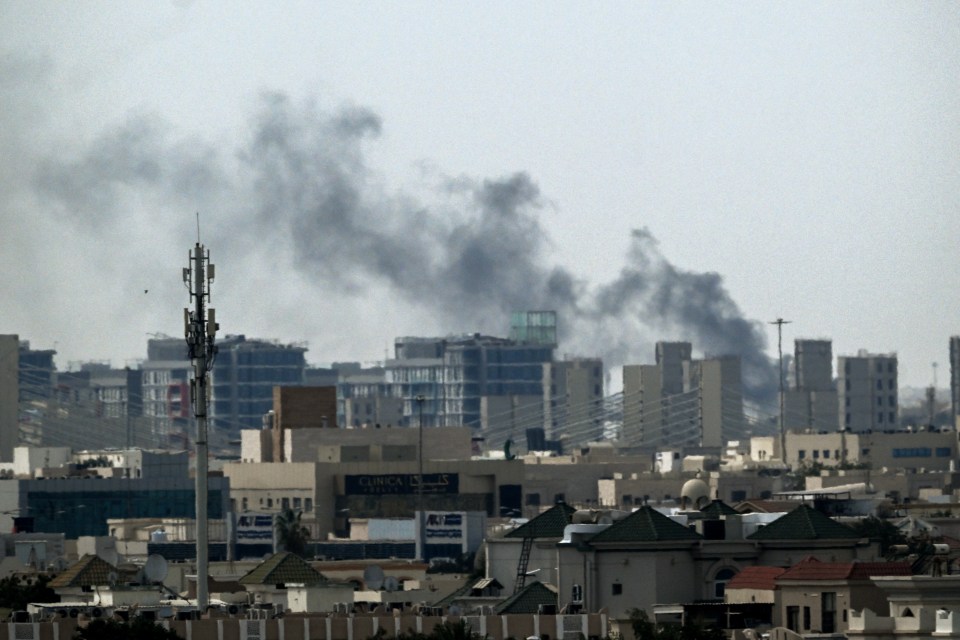 Plumes of smoke rising over buildings in Doha.