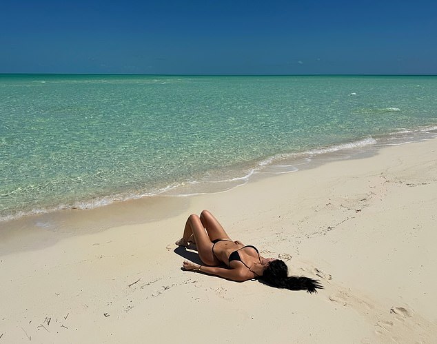 She put her famous curves on display as she nearly spilled out of her barely-there, low-cut bikini