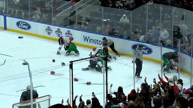 Helmets were tossed to the ice as players from both teams steamed in to join the violence