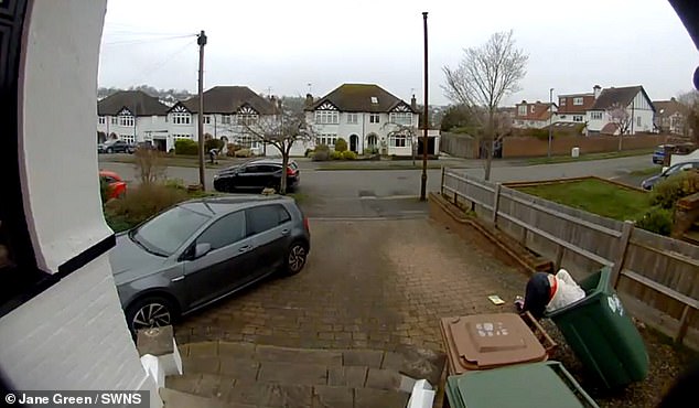 Ms Green (pictured) was mid-soaping down and washing the bin when its wheels rolled out from underneath her