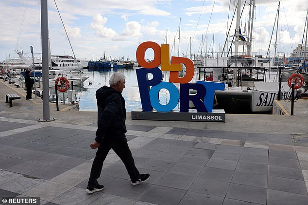 The country's location means the it is seeing a decline in its usual visitor numbers (Pictured: a man walks in the old port in Limassol, Cyprus, March 24)