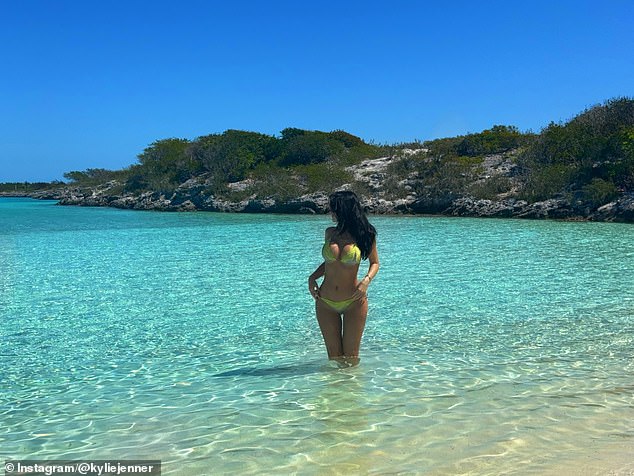 Jenner modeled the sexy swimsuit well as she sat on the shore and also slipped into the water to cool down
