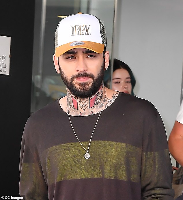 He also showed off his various inkings on his neck and arms and accessorised with a silver chain while leaving the studios