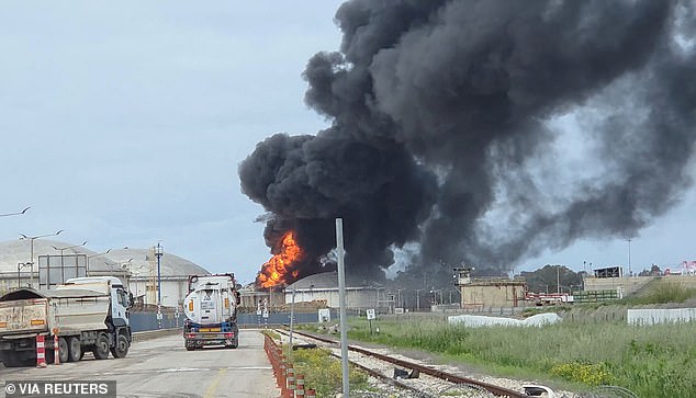 A fire is seen at an industrial building in Haifa, Israel on Monday after it was hit by debris from an intercepted Iranian missile. Daily Mail's polling has shown that Americans are willing to take an economic hit to ensure victory in the Iran war