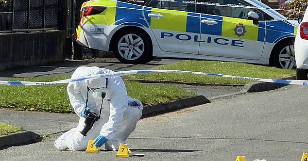 Specialist forensic officers sealed off the road and examined the area for evidence after a murder inquiry was launched
