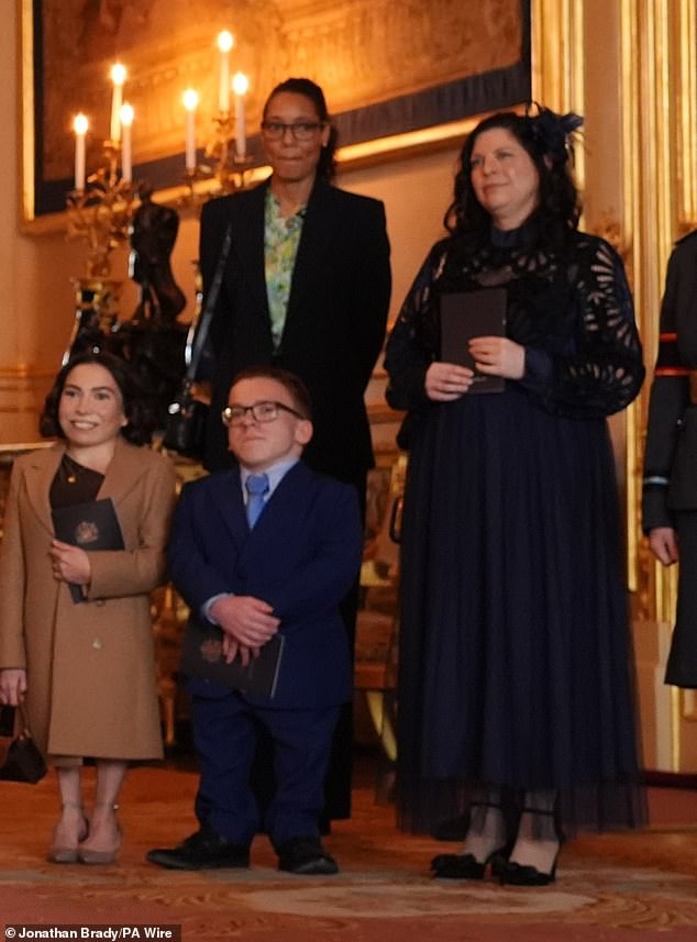 Philippa was photographed with a huge smile on her face as she stood alongside Davis’ daughter Annabelle, 29, and son Harrison, 23, as her partner recieved his OBE