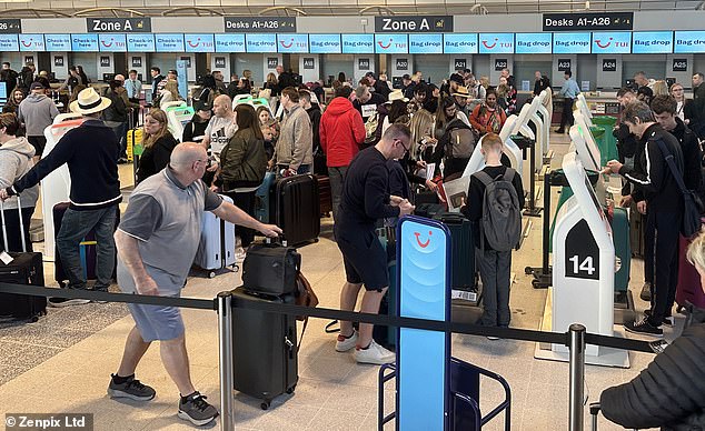 British holidaymakers could face long queues when travelling through European airports. Pictured: Crowds at Manchester Airport making their Easter getaway this morning