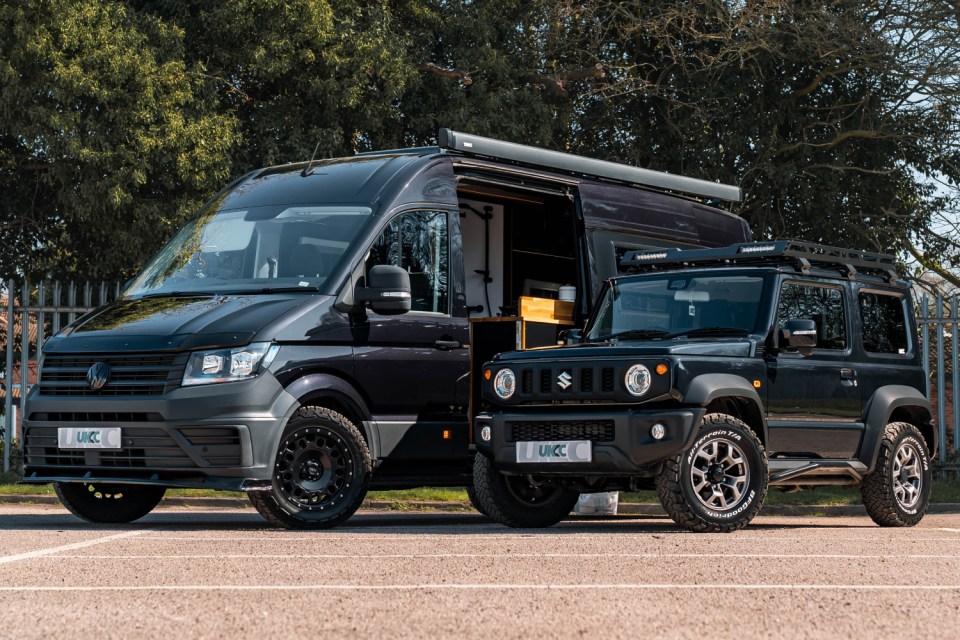 A black UKCC Crafter van next to a black UKCC Suzuki Jimny.