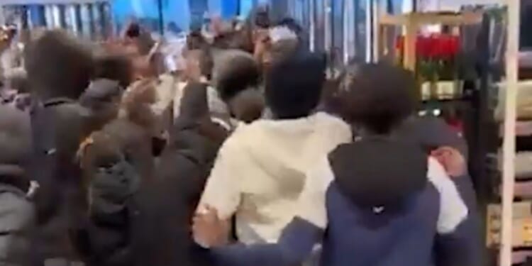 Shocking moment hooded mob of youngsters storm through M&S sparking huge brawl as police forced to break up chaos