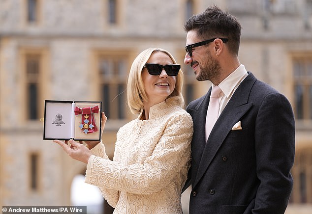 After accepting the CBE, the Promising Young Woman star was joined by her husband Marcus, who she married in 2012