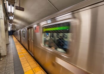 Subway train arriving at station in New York City underground transportation system.