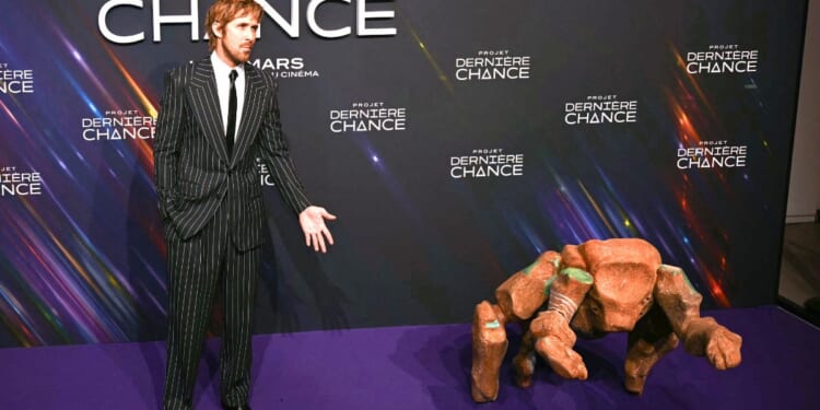 Actor Ryan Gosling and "Rocky" pose during a March 11 photocall before the screening of the movie 'Project Hail Mary' ("Projet Dernière Chance," or "Project Last Chance" in French) at the Pathe Palace Theater in Paris.