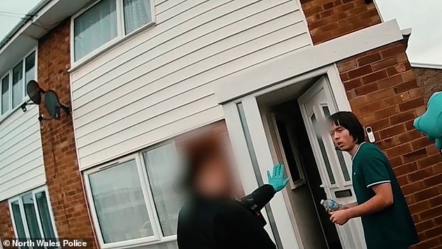 Tristan Roberts, 18, (pictured being arrested at his home after his mother's body was found on October 24) was jailed for life yesterday for bludgeoning his mother Angela Shellis to death with a hammer