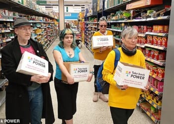 Activists took items from the shelves and put them in boxes labelled 'Take Back Power'