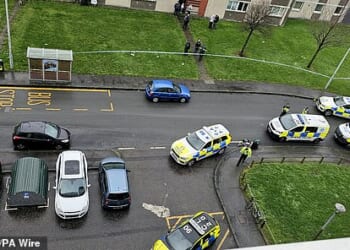 Police have warned the public to avoid part of Edinburgh after a man was seen brandishing two knives