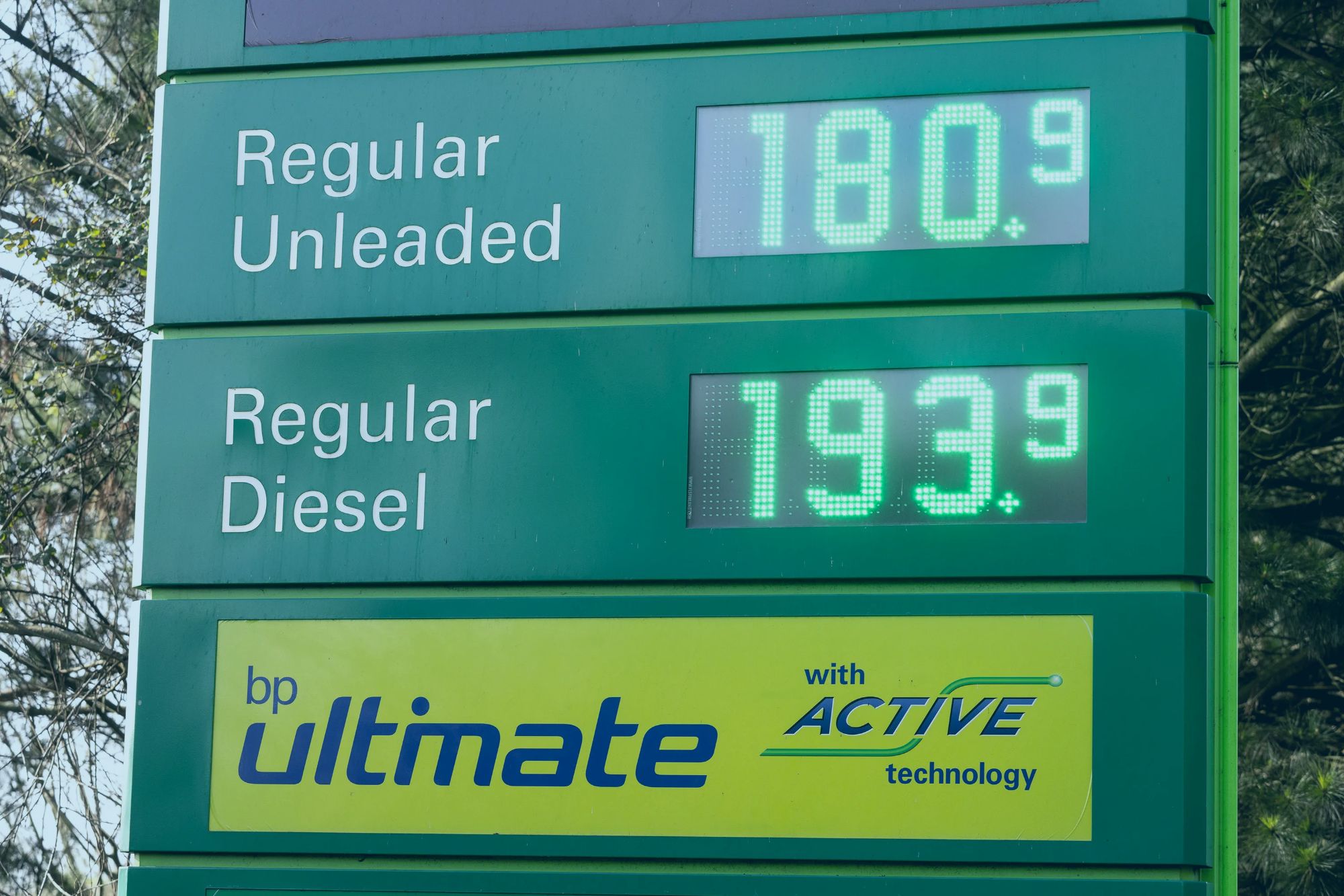 An image collage containing 1 images, Image 1 shows A BP petrol station sign displays "Regular Unleaded" at 180.9 and "Regular Diesel" at 193.9, with a "BP Ultimate" logo below