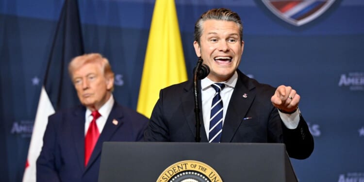 Defense Secretary Pete Hegseth addresses the audience as President Donald Trump listens during the Shield of the Americas Summit, a gathering with heads of state and government officials from 12 countries in the Americas at the Trump National Doral Golf Club on March 7, 2026, in Doral, Florida.