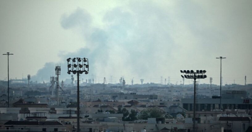 Smoke rises from an area in the direction of Al Udeid Air Base, which houses the Qatar Emiri Air Force and foreign forces including the United States, in Doha on Feb. 28, 2026, following a reported Iranian strike.