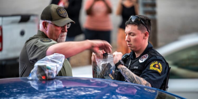 Police bag magazines of ammunition after arresting a man outside of a watch party for GOP Texas Senate Candidate Ken Paxton on March 3, 2026 in Dallas, Texas. Paxton is facing off against numerous candidates including incumbent Senator John Cornyn in the Republican Senate primary.