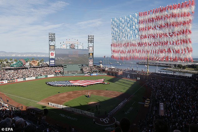 A drone pyrotechnic smoke display forms the American flag during the national anthem