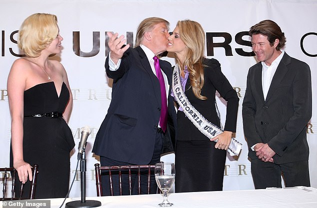 Donald Trump kisses Miss California USA, Carrie Prejean, and Miss California at a press conference at Trump Tower on May 12, 2009