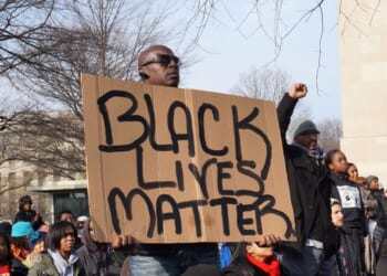 A man protests police brutality at an event led by Al Sharpton on Pennsylvania Avenue in Washington, D.C., on Dec. 13, 2014.