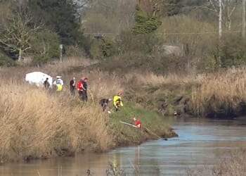 Emergency workers are pictured at the scene of the hunt for the missing teenagers in Cambridgeshire
