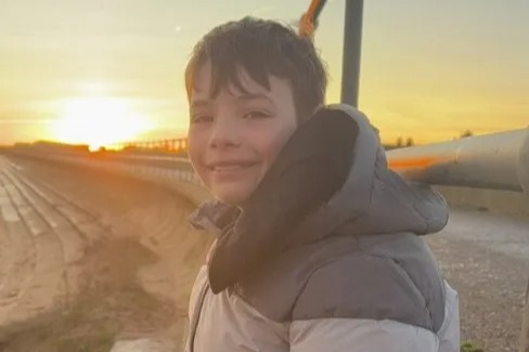 Boy, 13, killed after being hit by car while riding scooter is pictured as family pay touching tribute & 2 arrested