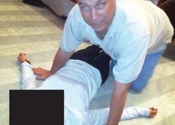 A Brazilian model told FBI investigators in 2020 that, after massaging him, Andrew Mountbatten-Windsor then told her 'it was her turn' before he massaged her 'back, shoulders, waist, and hands' at Jeffrey Epstein's townhouse in New York. Pictured: Andrew kneeling over an unidentified woman in an image that appears in the Epstein Files