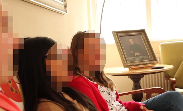 Pictured: A clip from the Ashwell House promotional video where girls casually hang out next to a gold-framed picture of a priest