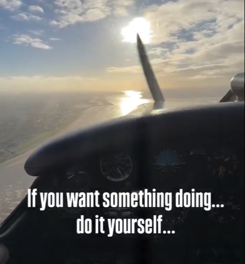 View from a small plane cockpit, looking towards the sun reflecting on water, with text overlay "If you want something doing... do it yourself..."