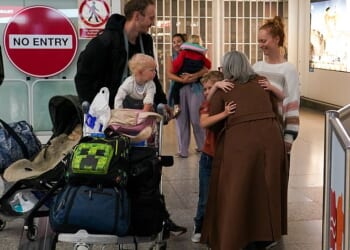 Brits pictured arriving at Stansted Airport early this morning, after a 'traumatic' journey back from the Middle East