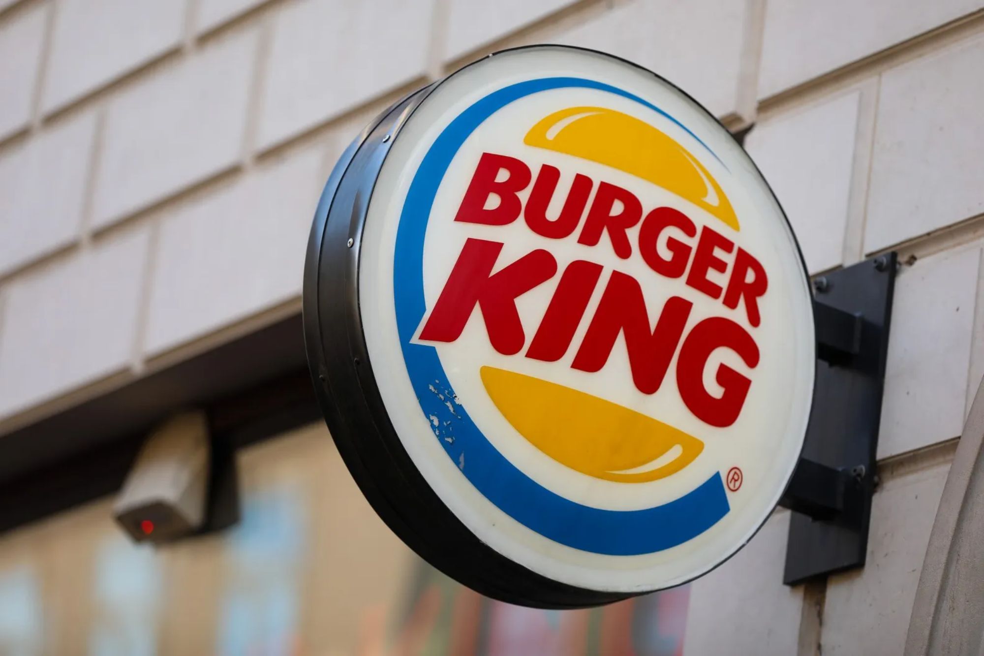 An image collage containing 1 images, Image 1 shows A Burger King sign hanging on a building